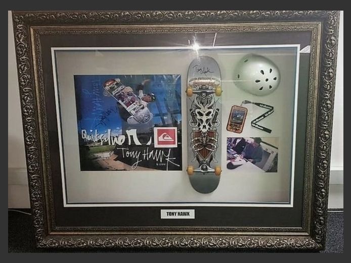 1.6 X 1.28 FRAMED MEMORABILIA OF TONY HAWK WITH ITEMS ORIGINALLY SIGNED BY TONY HAWK