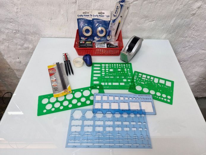 Assorted Office and Drafting Stationery Selection, Including Technical Drawing Templates and Desktop Accessories