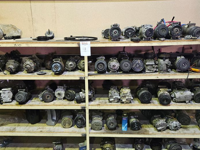 BEIGE COLOURED METAL SHELVES WITH VARIOUS COMPRESSORS