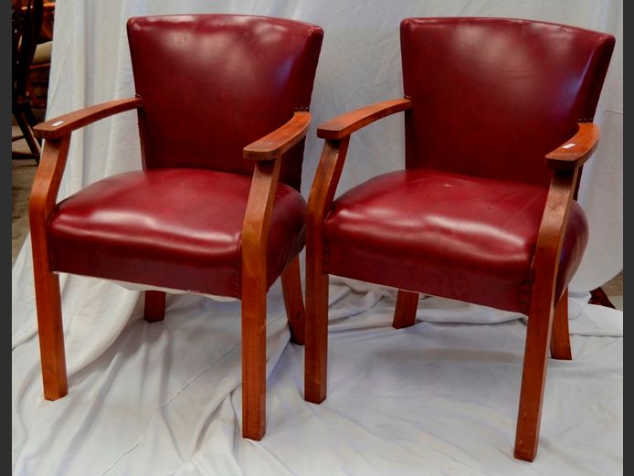 PAIR TEAK & BURGUNDY VINYL UPHOLSTERED ARMCHAIRS [Holes to upholstery on 1 chair]
