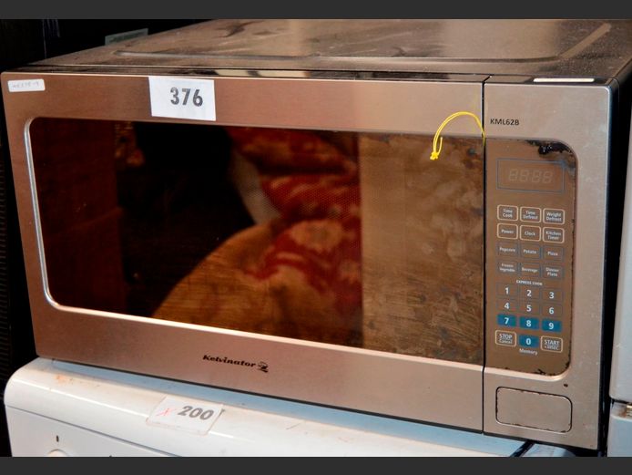 KELVINATOR STAINLESS STEEL ELECTRONIC MICROWAVE [Switches on, untested further, rusty, no plate, door opener rigged] [#: 425358995]