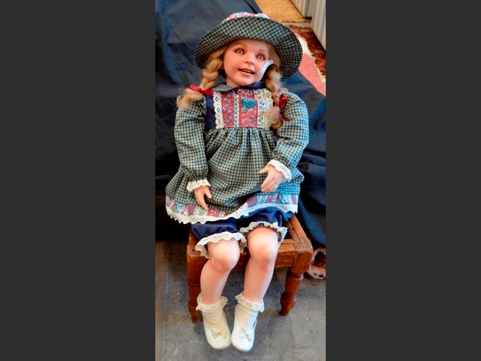 PORCELAIN DOLL ON ANTIQUE CHAIR