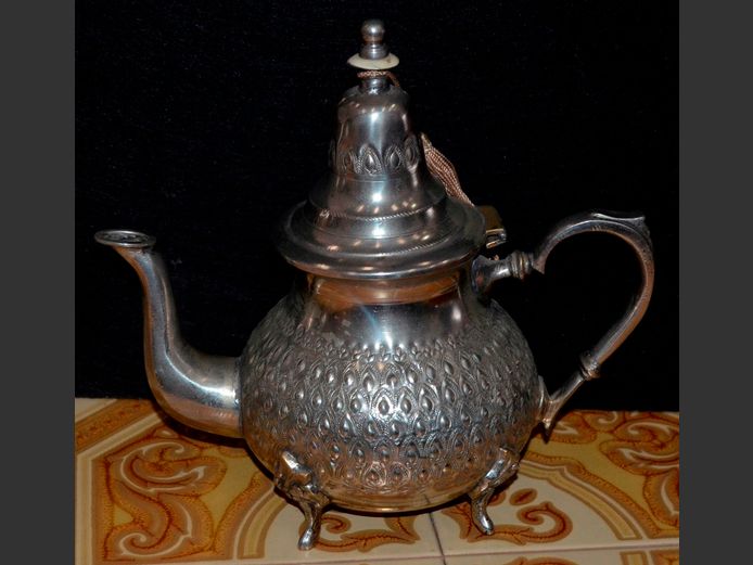 ORNATELY DECORATED SILVER PLATE FOOTED TEAPOT, 23cm High