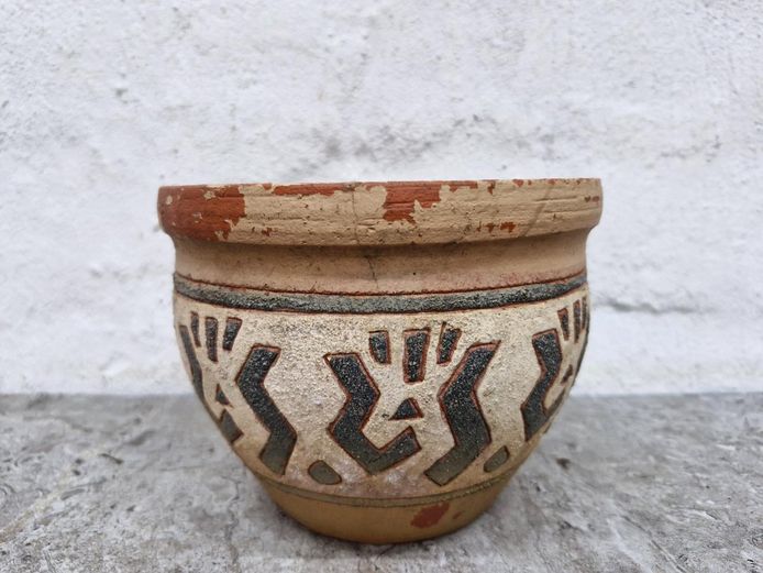 Rustic Terracotta Planter with Stylized Tribal Engravings