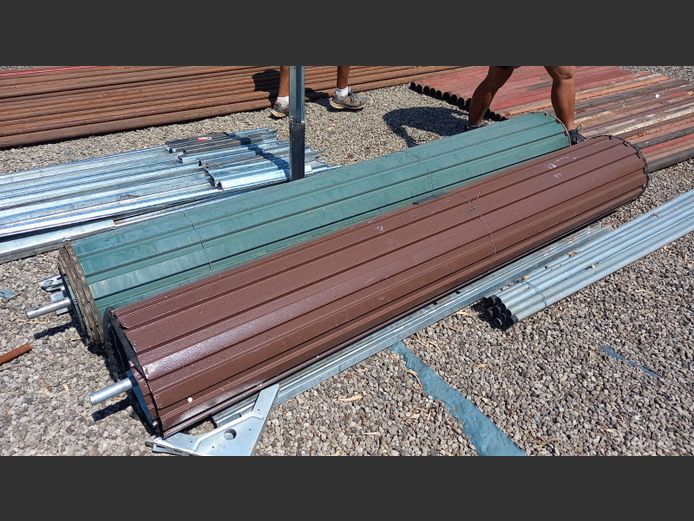 2x Garage doors with rails. Brown door is standard size, Green door extended length