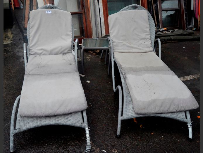 PAIR ALL WEATHER WICKER SUN LOUNGERS & A GLASS TOP SIDE TABLE [Fabric damaged, wicker loose in places], 220 x 80cm