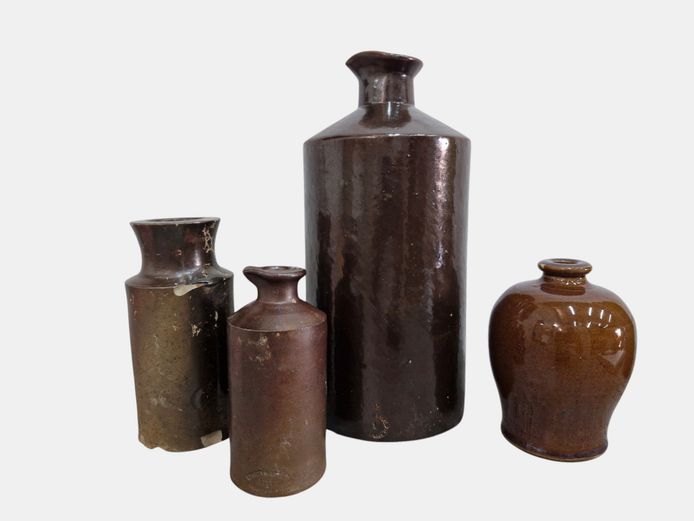 Group of Four Brown Stoneware Utility Bottles