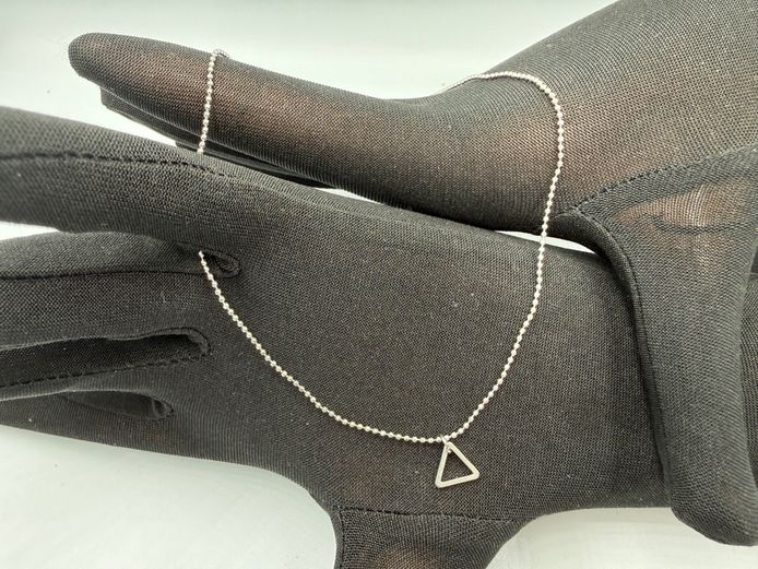 Fine silver coloured necklace with triangular charm