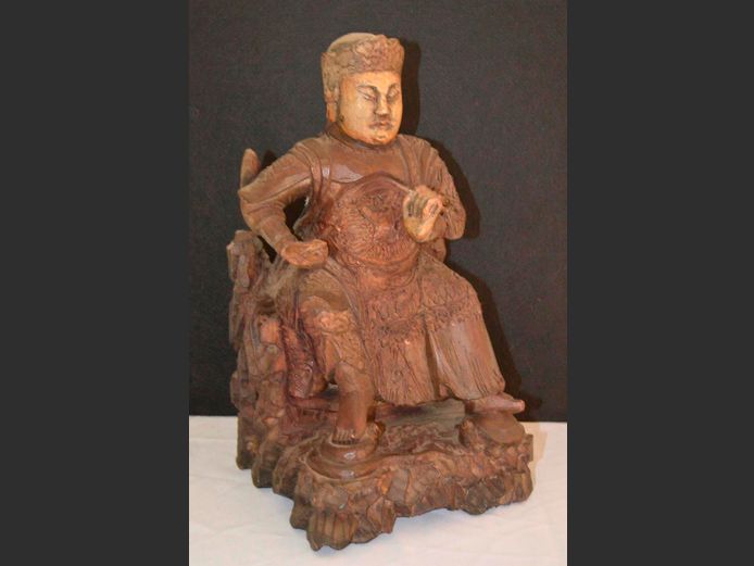 ANTIQUE CARVED FIGURINE OF A SEATED WARRIOR GOD, 20 x 21 x 39cm
