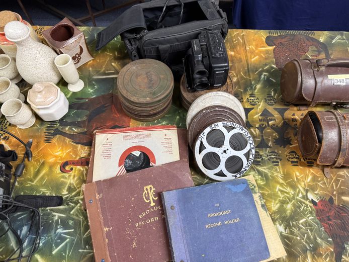 Vintage film reels, records, video recorder and metal case with batteries and charger