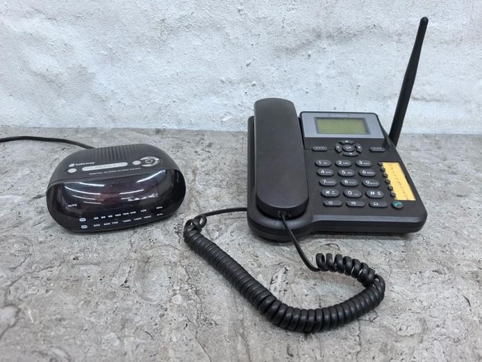 Black Huawei Fixed Wireless Phone and Safeway Clock Radio