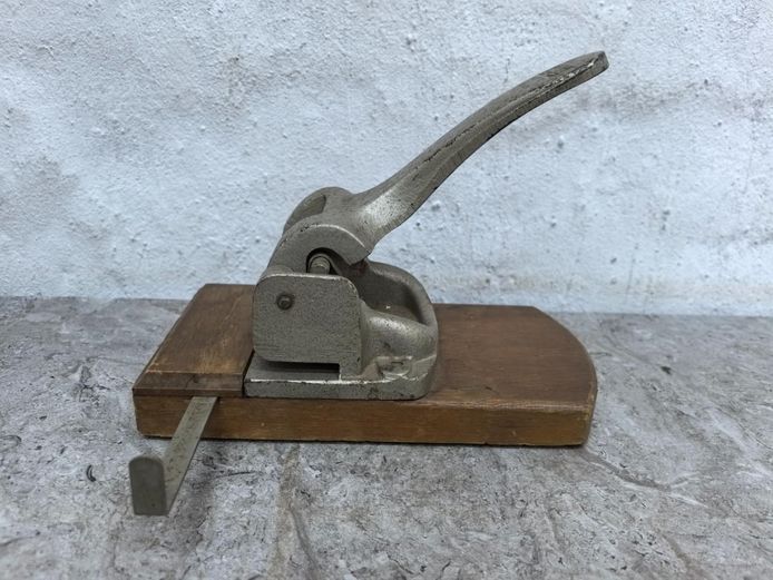 Vintage Industrial Heavy-Duty Cast Metal Paper Punch on Wooden Base
